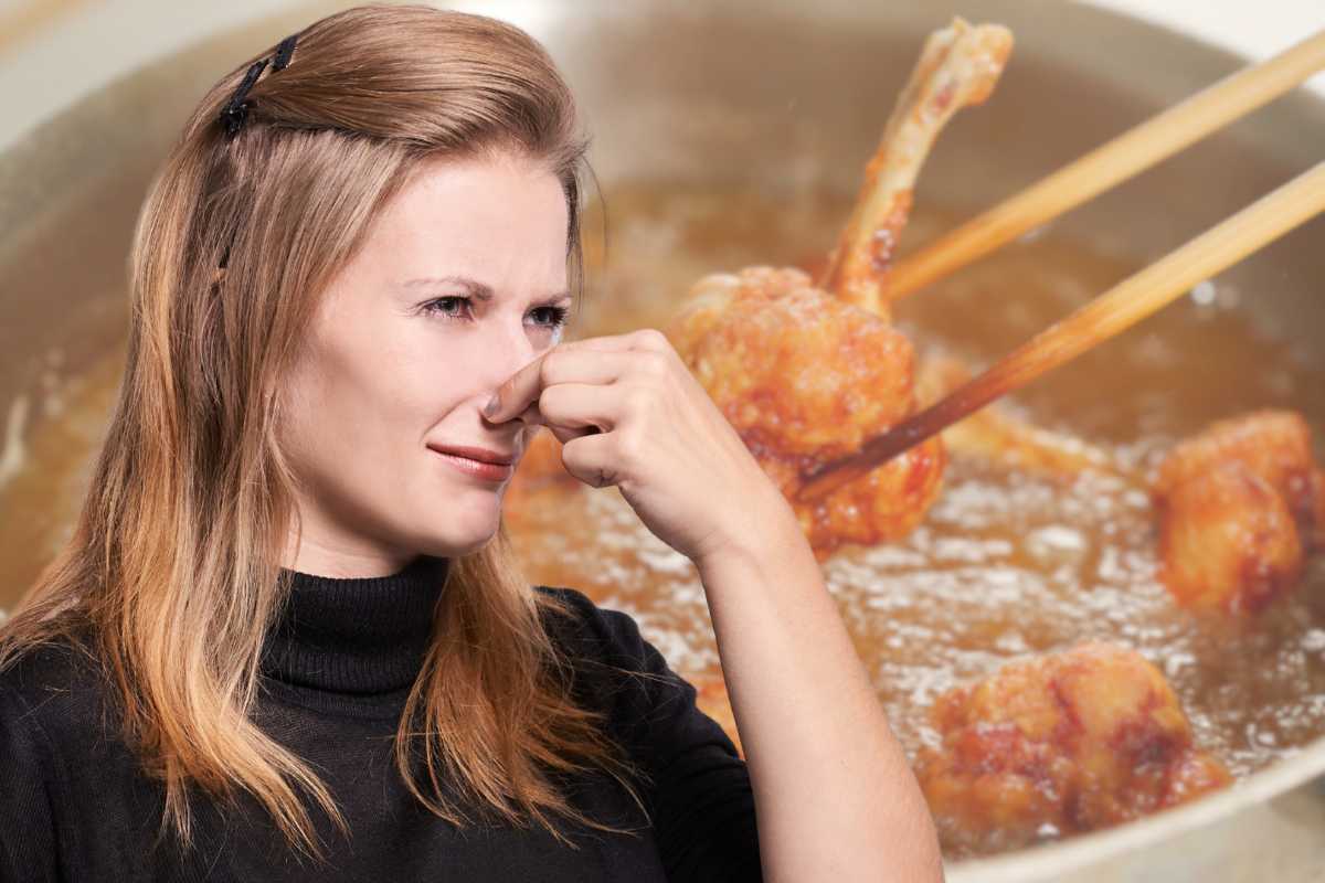 donna che si tappa il naso e friggere alimenti